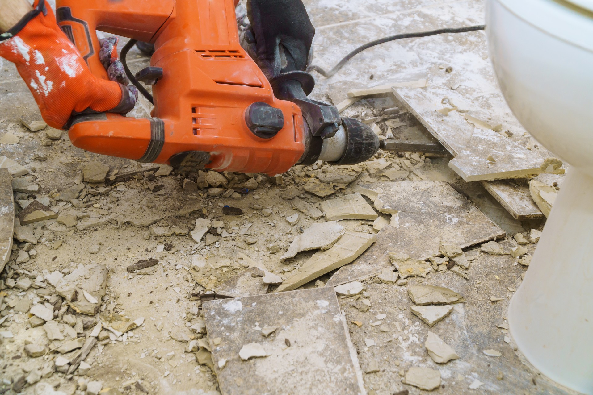 Demolition of old tiles with jackhammer. Renovation of old floor.